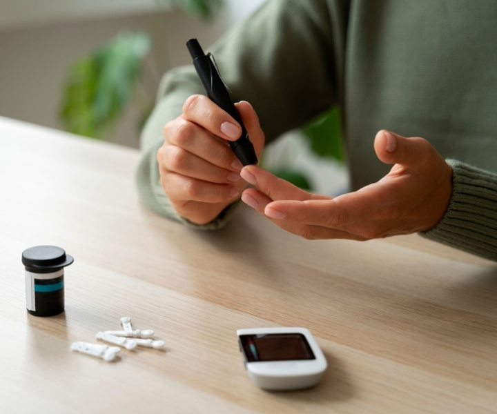 Person checking blood sugar with glucometer